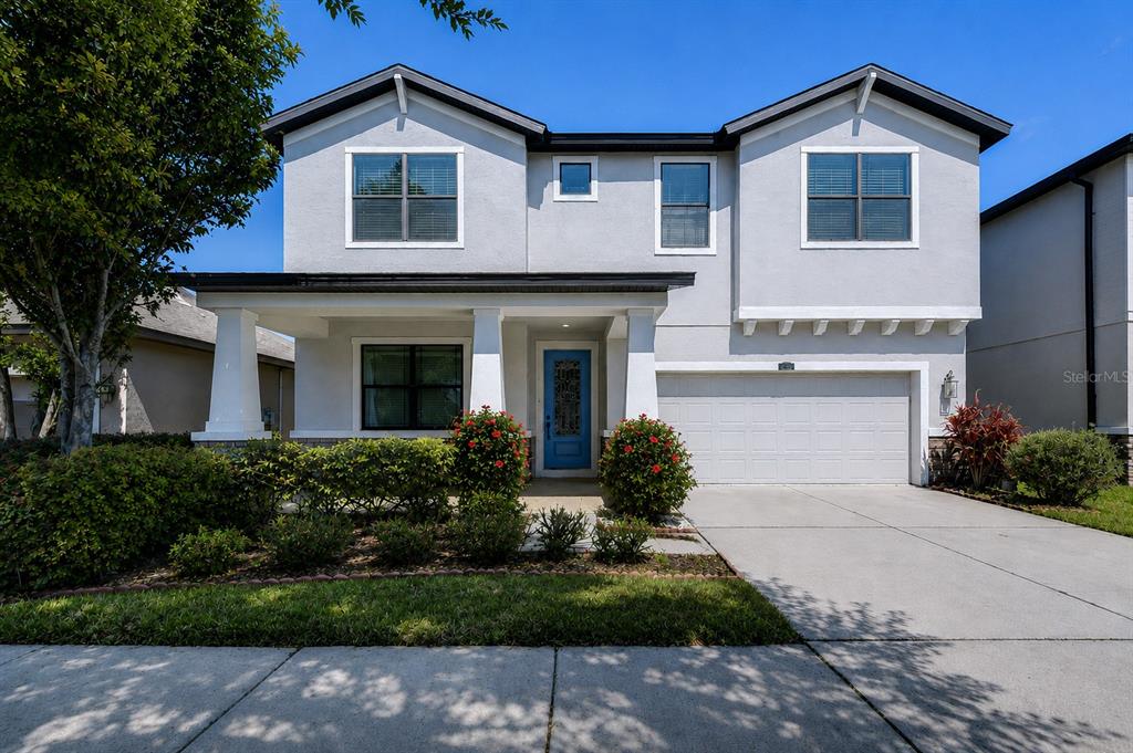 A two-story suburban house with a gray exterior, a front porch, and a two-car garage — 871 VINO VERDE CIRCLE, BRANDON, FL