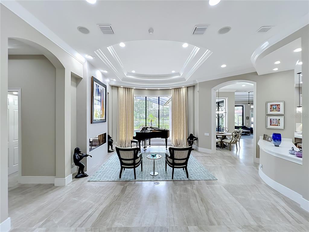A modern house exterior features a paver driveway, a white garage door, and a dark entryway — 4205 CLARICE ESTATES DRIVE, WINDERMERE, FL