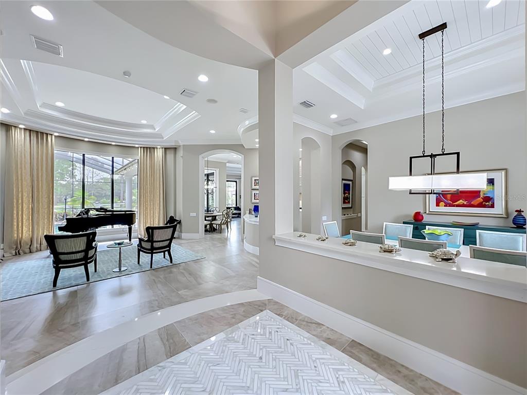 A modern house exterior features a paved driveway, a garage, and a covered front entryway — 4205 CLARICE ESTATES DRIVE, WINDERMERE, FL