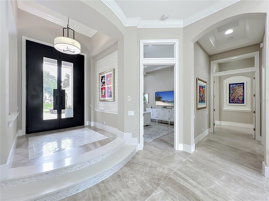 A spacious living room features a grand piano, a fireplace, and a tray ceiling — 4205 CLARICE ESTATES DRIVE, WINDERMERE, FL