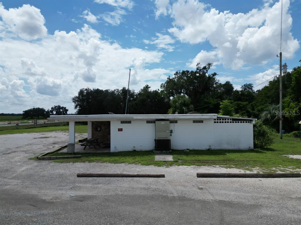 A single-story white building with a stone accent wall and a covered front porch area — 5025 TREIMAN BOULEVARD, DADE CITY, FL