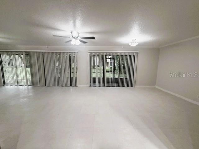 A spacious room with white tile floors, two sets of vertical blinds, and ceiling lights — 280 MOREE LOOP UNIT 2, WINTER SPRINGS, FL