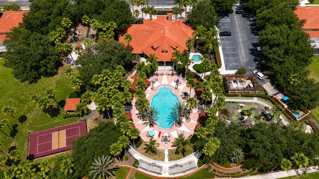 An aerial view shows a community clubhouse with a pool, tennis court, and putting green — 1153 SOLANA CIRCLE, DAVENPORT, FL