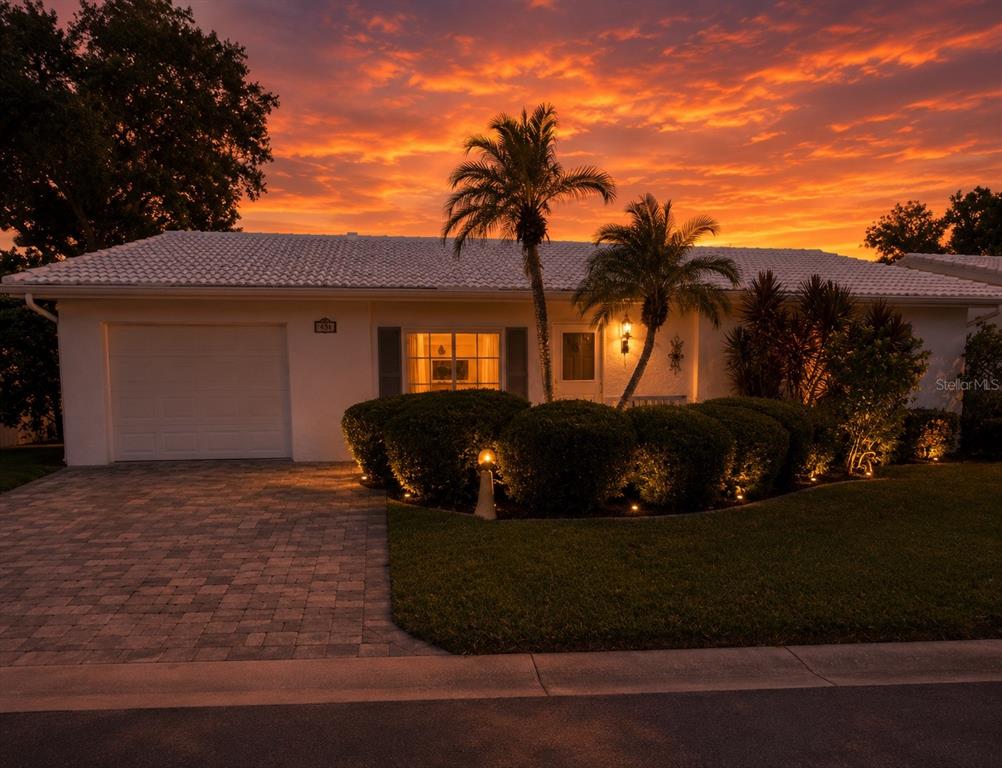 A white, single-story house with a tiled roof, a paved driveway, and palm trees — 9021 41ST WAY N UNIT 0, PINELLAS PARK, FL
