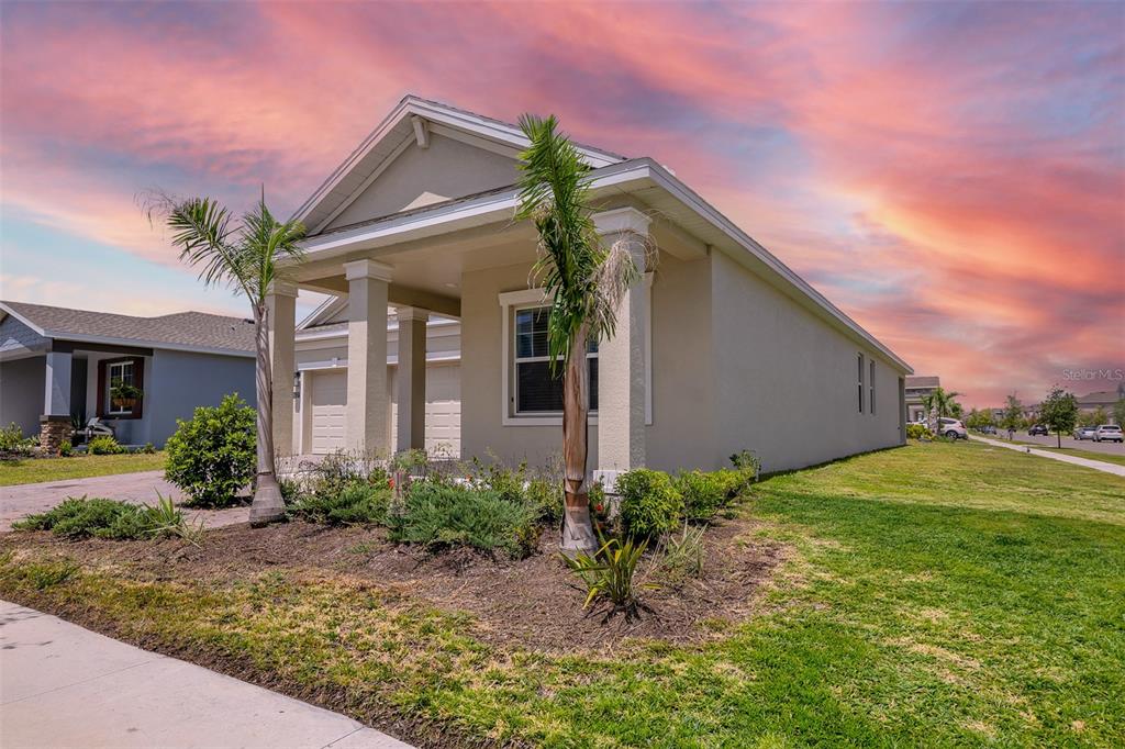 A tan single-story house with a covered front porch and two palm trees in front — 2637 PEACE OF MIND AVENUE, KISSIMMEE, FL