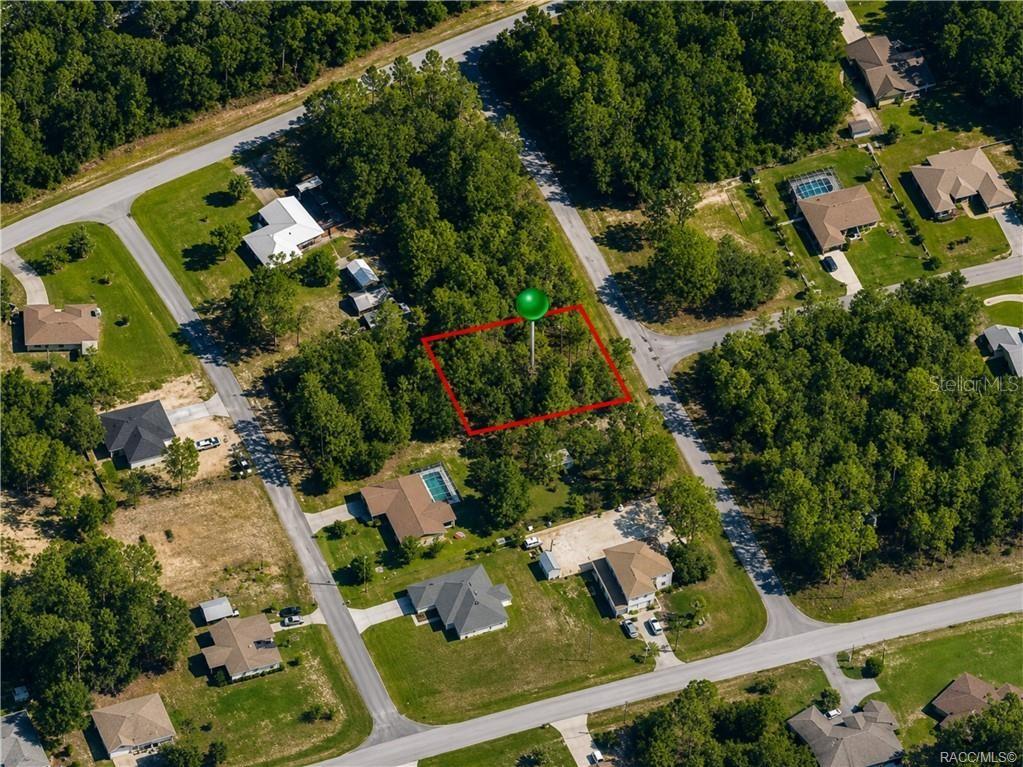 This aerial view shows a vacant, wooded residential lot outlined in red — 7938 N RYAN WAY, CITRUS SPRINGS, FL