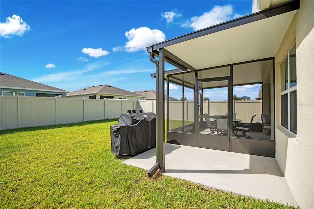 A covered patio with a screen enclosure, outdoor furniture, and a view of the backyard — 3768 BOTANICAL WAY, SANFORD, FL