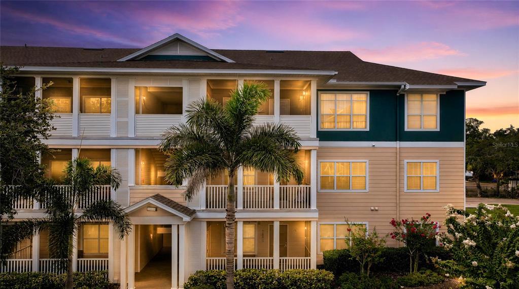 An exterior view of a building entrance with a screen door and a welcome mat — 4802 51ST STREET W UNIT 1410, BRADENTON, FL