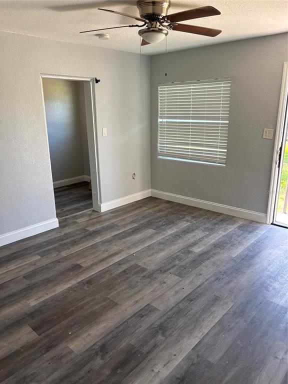 An empty room features gray walls, wood-look flooring, a ceiling fan, and a window with blinds — 4321 LAKE LAWNE AVENUE, ORLANDO, FL