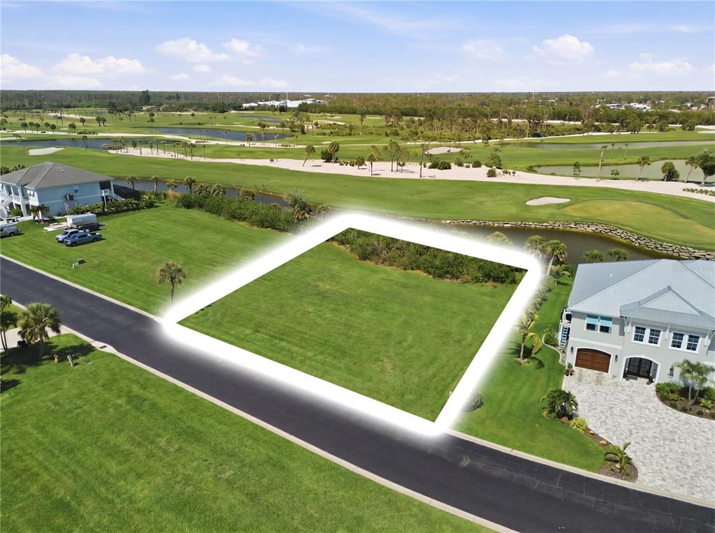 An aerial view shows a vacant, rectangular residential lot situated next to a golf course — 10000 EAGLE PRESERVE DRIVE, ENGLEWOOD, FL