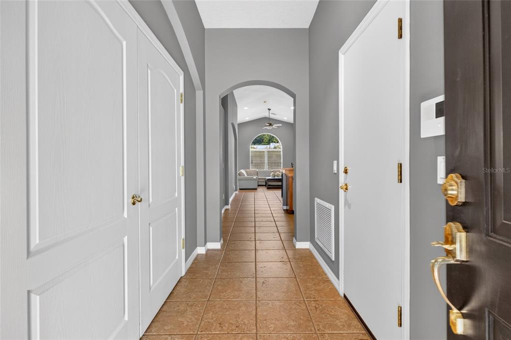 A kitchen features wood cabinets, stainless steel appliances, a breakfast bar, and tile flooring — 4618 CONROY CLUB DRIVE, ORLANDO, FL