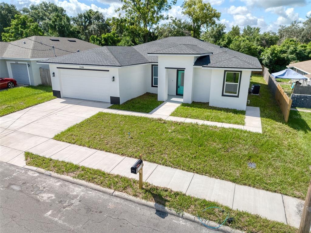 The exterior entrance features a teal front door with a glass panel and a lantern — 1246 HERSCHELL STREET, LAKELAND, FL