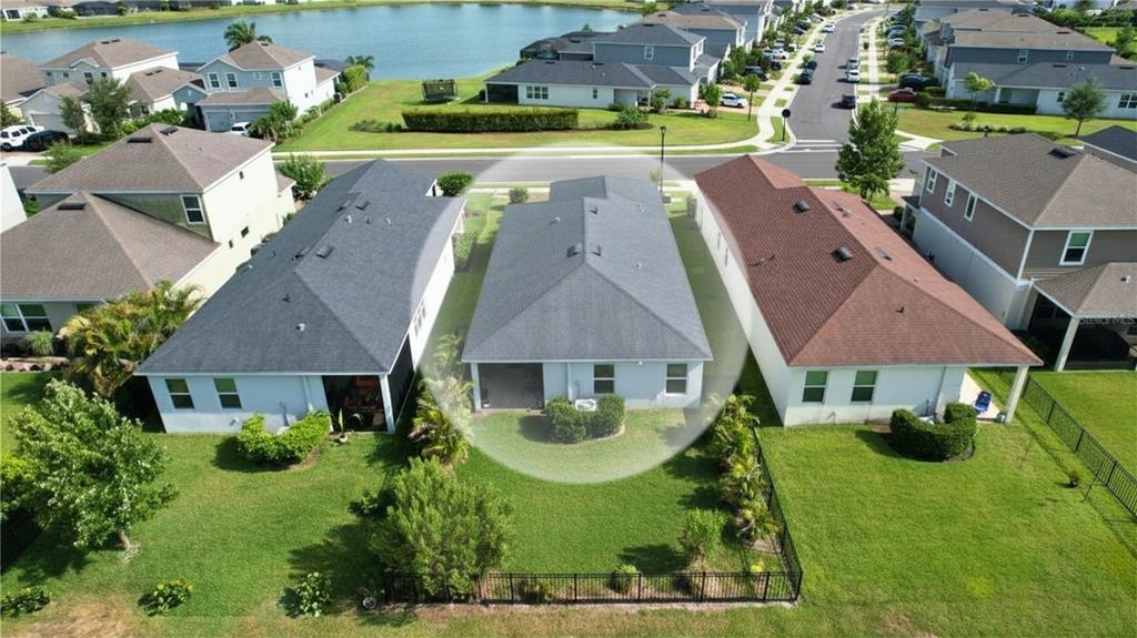 An aerial view shows a residential neighborhood with a highlighted house facing a large pond — 11636 LITTLE RIVER WAY, PARRISH, FL