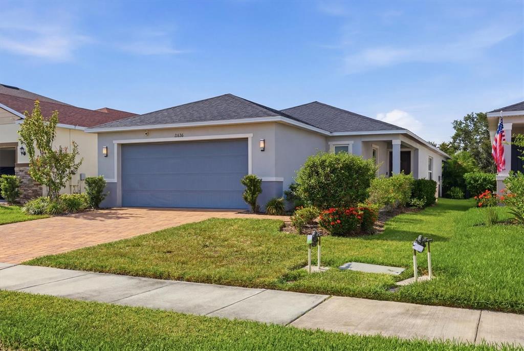 An aerial view shows a suburban neighborhood with a highlighted house bordering a wooded area — 11636 LITTLE RIVER WAY, PARRISH, FL