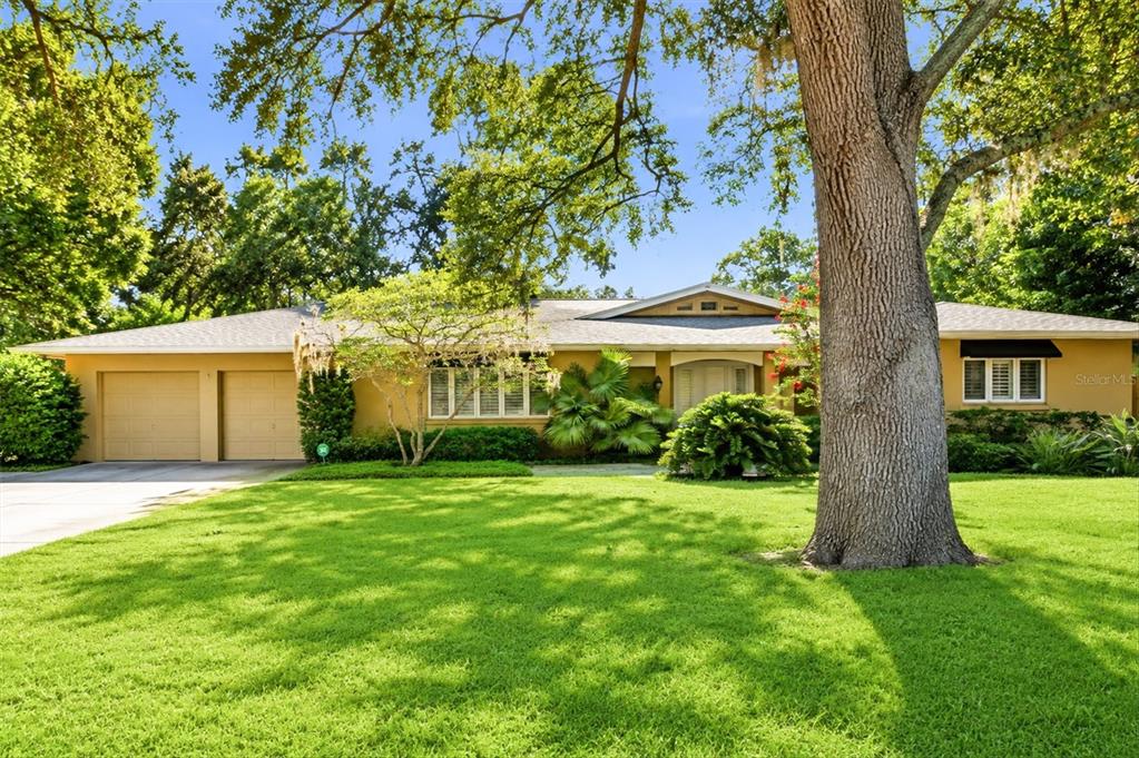 A single-story house with a two-car garage, large front lawn, and a prominent oak tree — 1041 CITRUS AVENUE, SARASOTA, FL