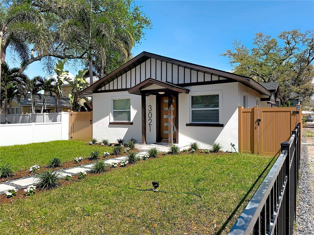A white single-story house with a brown gabled roof and a front walkway — 3021 GRANVILLE COURT N, ST PETERSBURG, FL