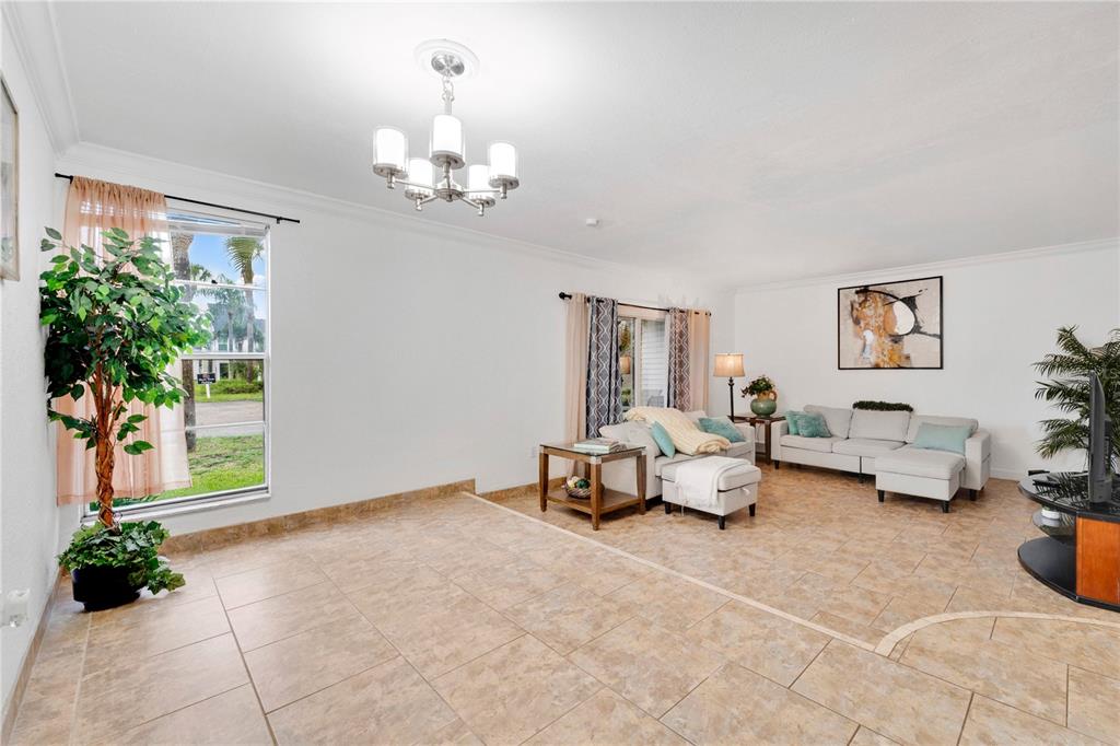 A swimming pool sits in the center of a courtyard surrounded by multi-story apartment buildings — 654 HAVEN PLACE UNIT 654, TARPON SPRINGS, FL