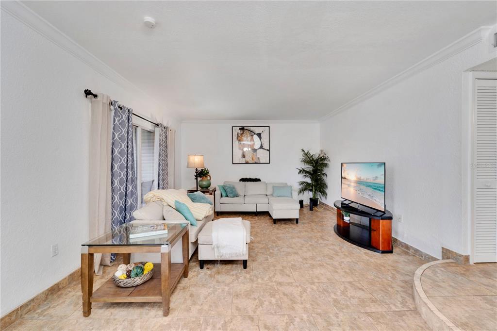 A narrow outdoor walkway leads to a set of stairs and a dark entry door — 654 HAVEN PLACE UNIT 654, TARPON SPRINGS, FL