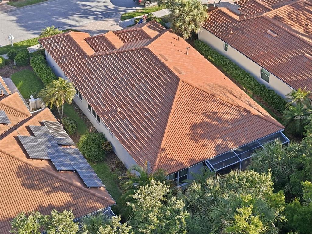 An aerial view of a house with a tile roof and solar panels — 5127 HANGING MOSS LANE, SARASOTA, FL