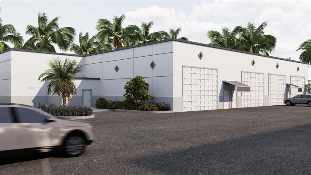 This is a rendering of a modern, white commercial warehouse building with multiple roll-up doors — 5237 TAYLOR ROAD UNIT E9, PUNTA GORDA, FL