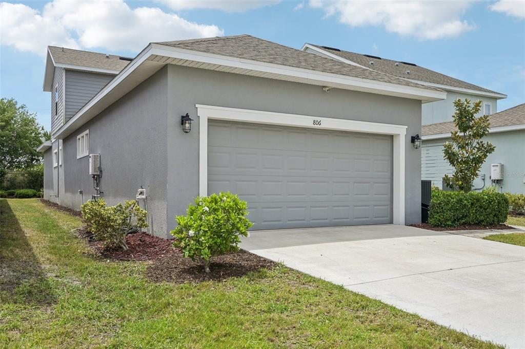 A gray two-story house features a two-car garage and a concrete driveway — 806 WINTERSIDE DRIVE, APOLLO BEACH, FL