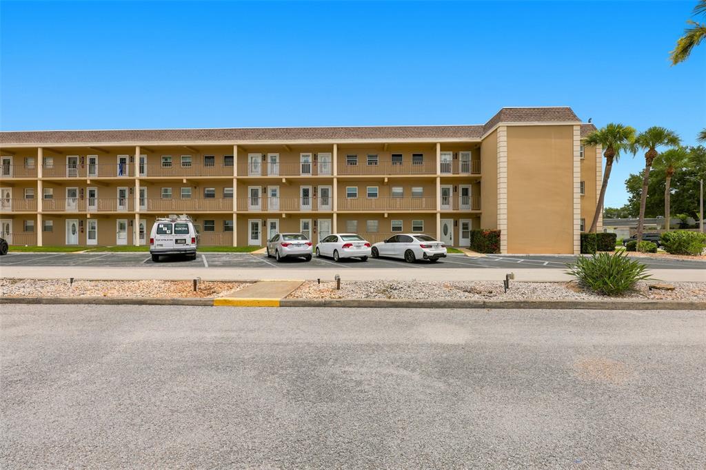 An exterior entryway features two white doors, a black address sign, and an exit sign — 1 BOCA CIEGA POINT BOULEVARD UNIT 316, ST PETERSBURG, FL