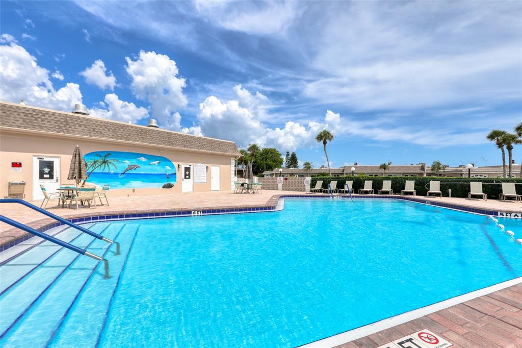 An aerial view of a multi-story apartment building next to a canal and boat docks — 1 BOCA CIEGA POINT BOULEVARD UNIT 316, ST PETERSBURG, FL