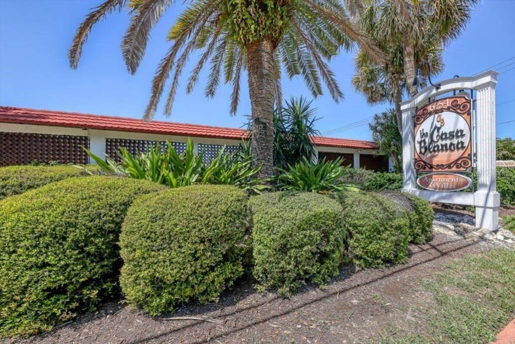 A sign for The Casa Blanca Apartments and Villas stands in front of a building — 6154 MIDNIGHT PASS ROAD UNIT 7C, SARASOTA, FL