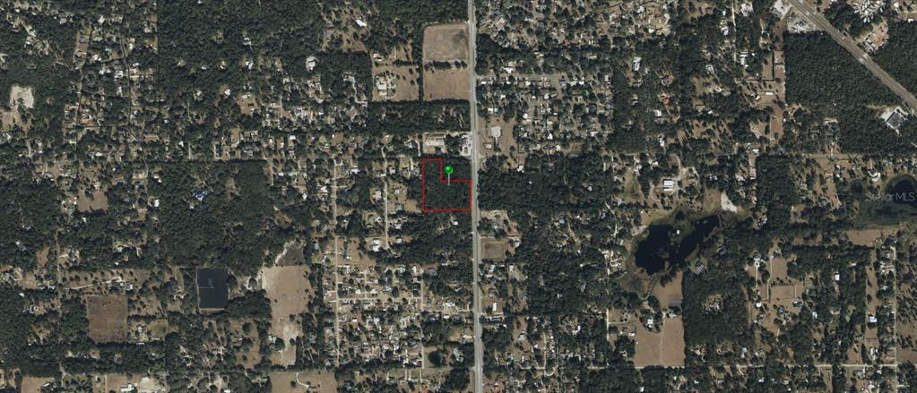An aerial map view shows a rectangular plot of land outlined in red — N SPRING GARDEN AVENUE, DELAND, FL