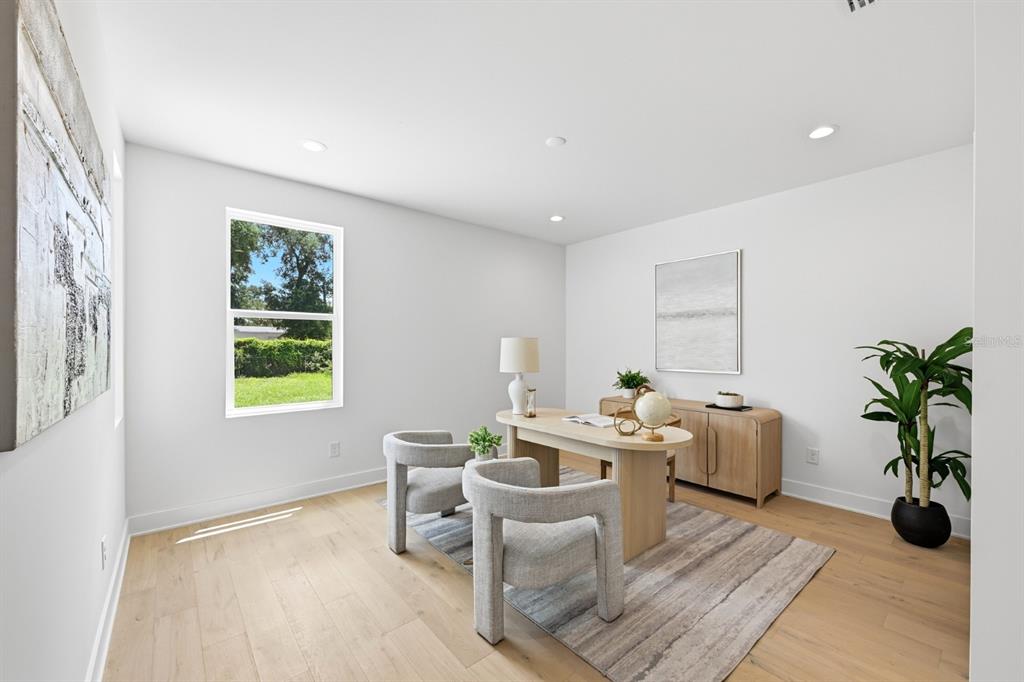 A bright home office features light wood flooring, a curved desk, and two upholstered chairs — 310 W COLUMBUS DRIVE UNIT 8, TAMPA, FL