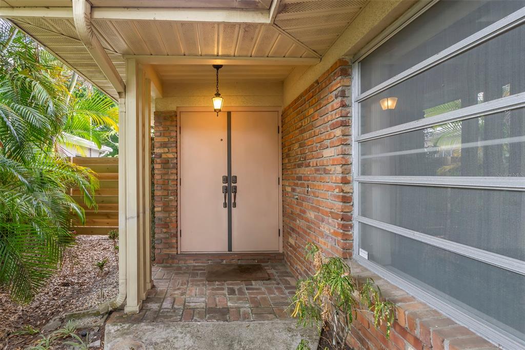 A single-story house with a brick driveway, a two-car garage, and large mature trees — 2616 S TORONTO AVENUE, TAMPA, FL
