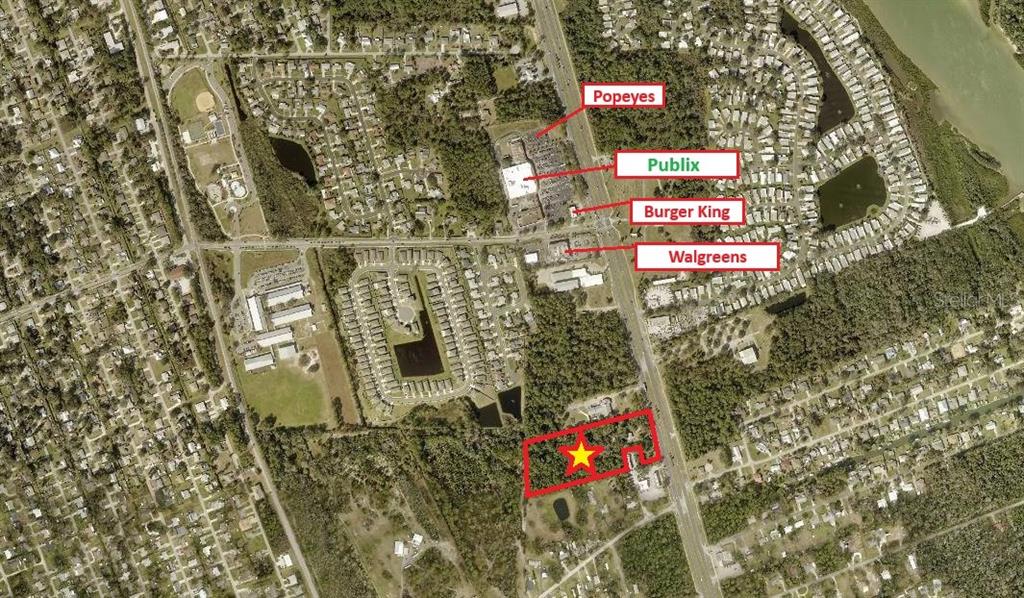 This is an aerial map showing a vacant lot marked with a star near businesses — 3258 S RIDGEWOOD AVENUE, EDGEWATER, FL