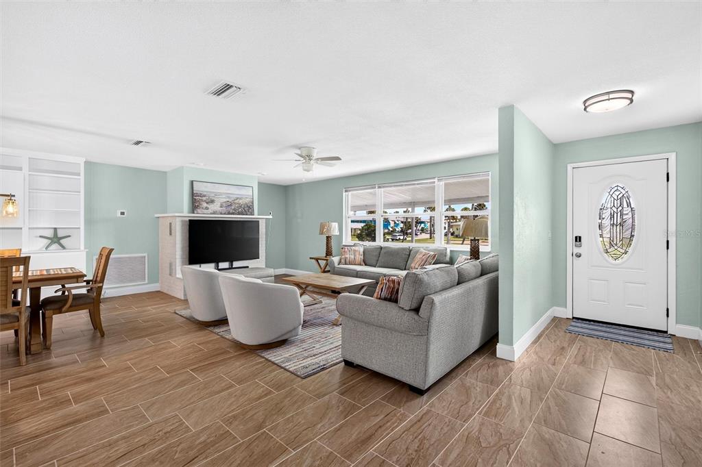 A view from a doorway shows a light-walled hallway leading into an open-concept living area — 341 PLAZA BOULEVARD, DAYTONA BEACH, FL