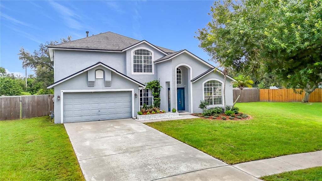 A two-story house with a gray stucco exterior, a two-car garage, and a concrete driveway — 1639 LEDGESTONE DRIVE, BRANDON, FL