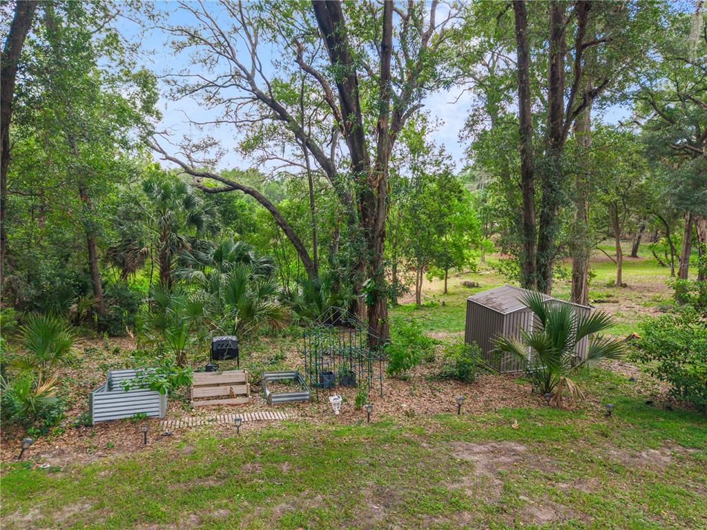 A modern kitchen with white cabinets, a breakfast bar, and a stone fireplace nearby — 1937 HIDDEN PINE LANE, APOPKA, FL