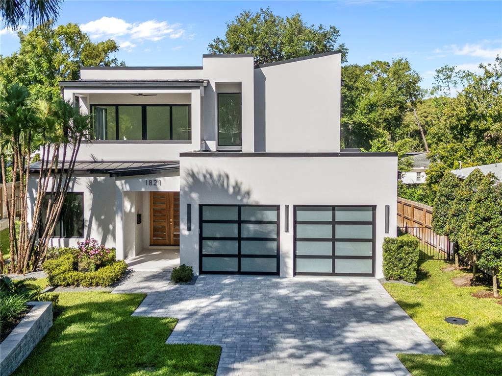 A modern two-story house with a white exterior, flat roof, and a paved driveway — 1821 ENGLEWOOD ROAD, WINTER PARK, FL