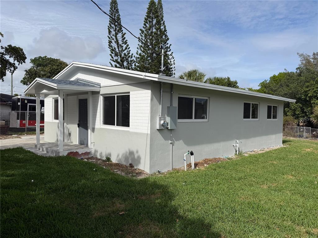 A single-story house with a light gray exterior, a small front porch, and a grassy yard — 836 SW 2ND TERRACE, DEERFIELD BEACH, FL