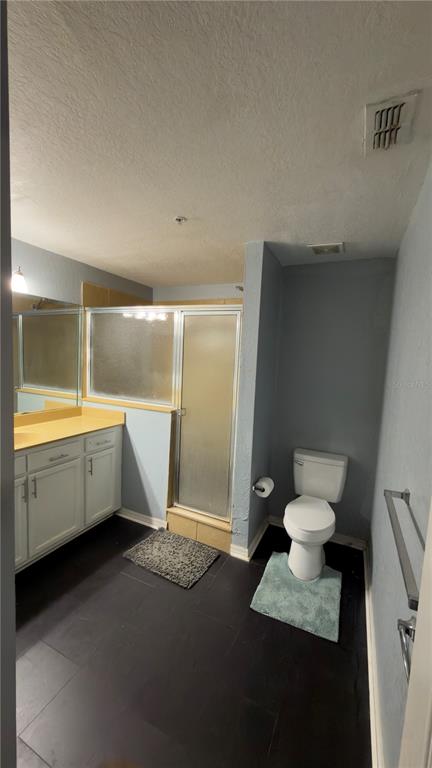 A bathroom features a vanity with a yellow countertop, a glass shower, and a toilet — 5031 SUNRIDGE PALMS DRIVE, TAMPA, FL