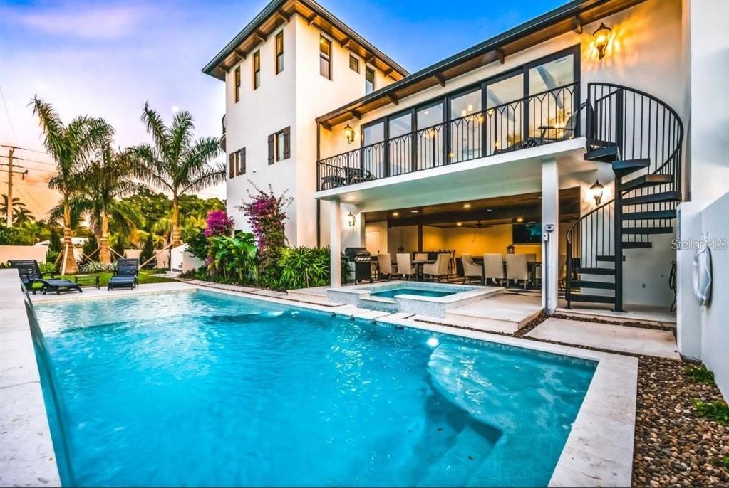 A two-story house exterior features a swimming pool, a hot tub, and a spiral staircase — 340 JACKSON DRIVE, SARASOTA, FL