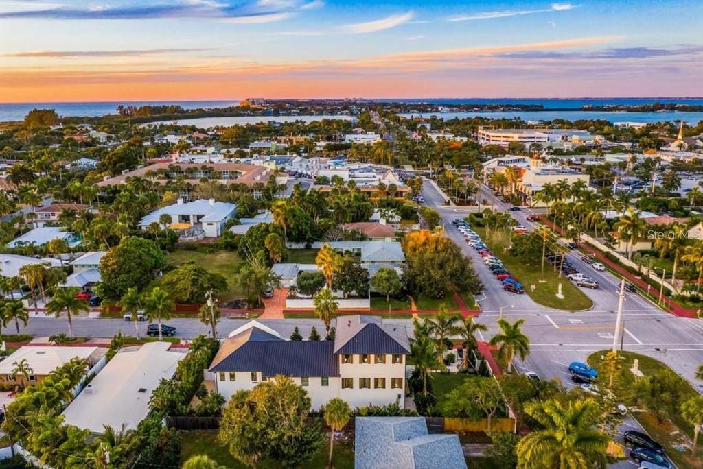 An aerial view of a coastal town featuring a large house with a dark roof — 340 JACKSON DRIVE, SARASOTA, FL