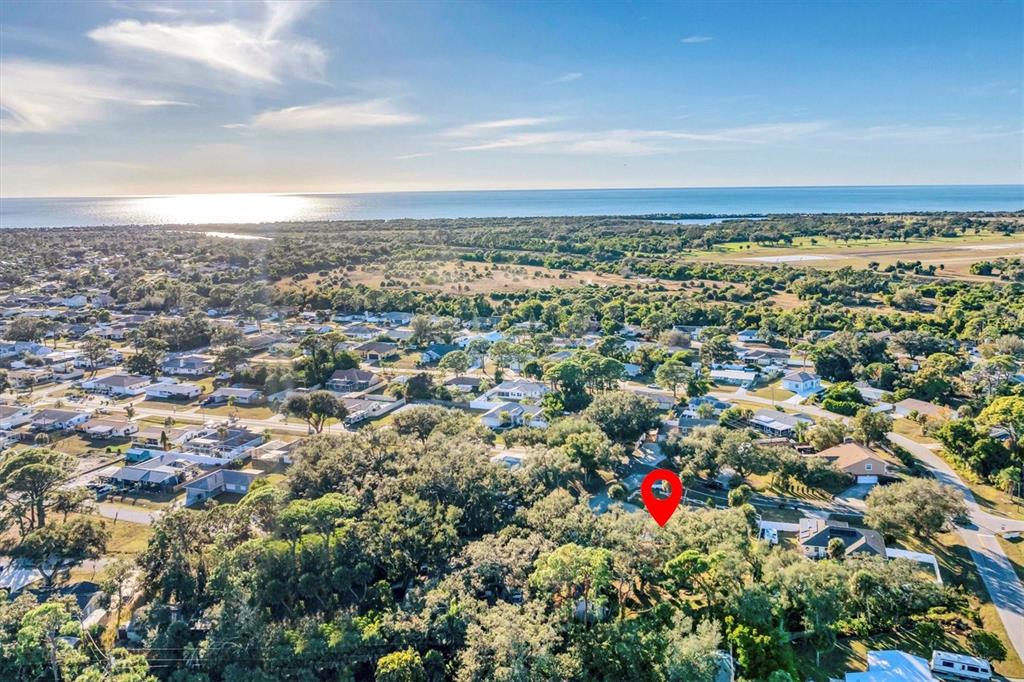 An aerial view shows a residential neighborhood with a red location pin over trees — 2745 ARROWHEAD ROAD, VENICE, FL