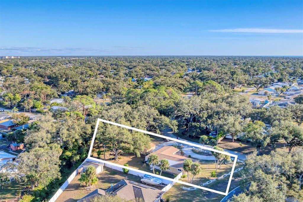 An aerial view shows a single-story house with a large yard and mature trees — 2745 ARROWHEAD ROAD, VENICE, FL