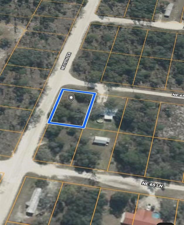 This is an aerial map view of a vacant, rectangular lot outlined in blue — 0 NE 119TH TERRACE, WILLISTON, FL