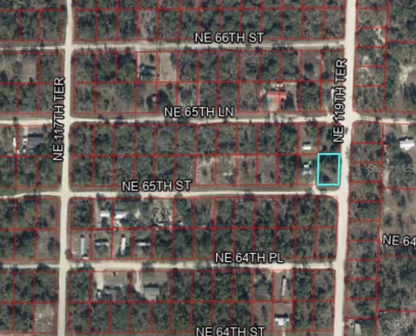 This is an aerial map showing a highlighted vacant lot at a street intersection — 0 NE 119TH TERRACE, WILLISTON, FL
