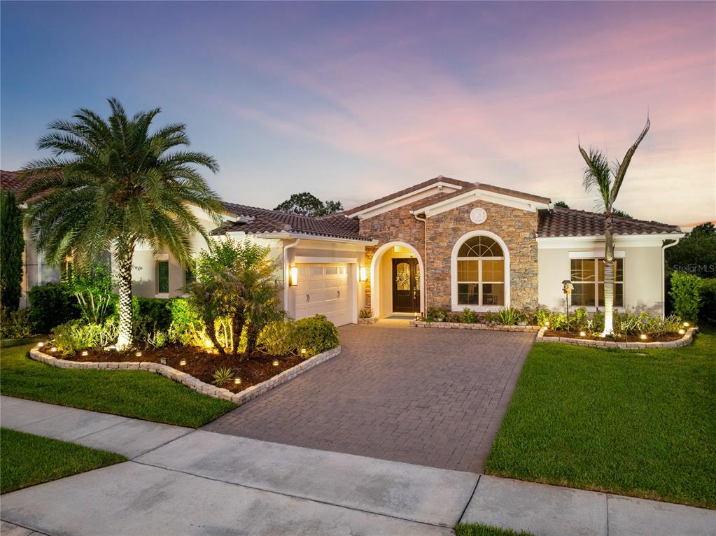A screened-in patio features a swimming pool, a hot tub, and an outdoor kitchen area — 13391 ALDERLEY DRIVE, ORLANDO, FL