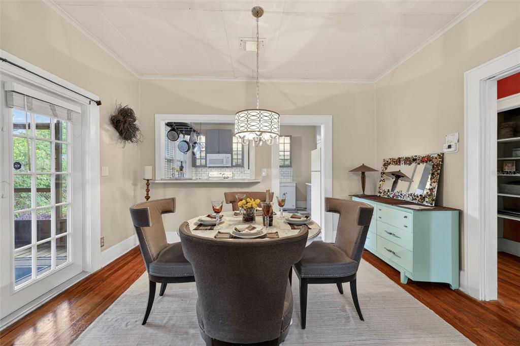 A dining room with a round table, four chairs, a light blue dresser, and hardwood floors — 2535 15TH AVENUE N, ST PETERSBURG, FL
