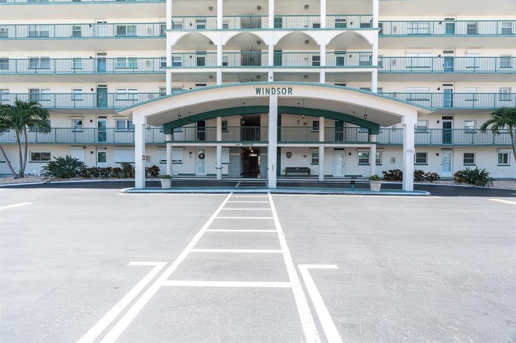 A multi-story apartment building features a covered entrance with the name Windsor displayed above — 6020 SHORE BOULEVARD S UNIT 412, GULFPORT, FL