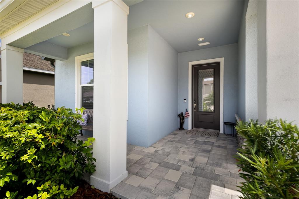 A light blue single-story house features a three-car garage and a landscaped front yard — 8611 MERCATOR COURT, PARRISH, FL