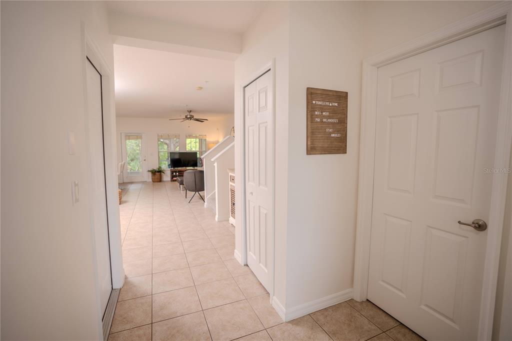 A bedroom features a tufted beige bed, a floor mirror, and a ceiling fan — 9734 TIRAMASU TRAIL, ORLANDO, FL