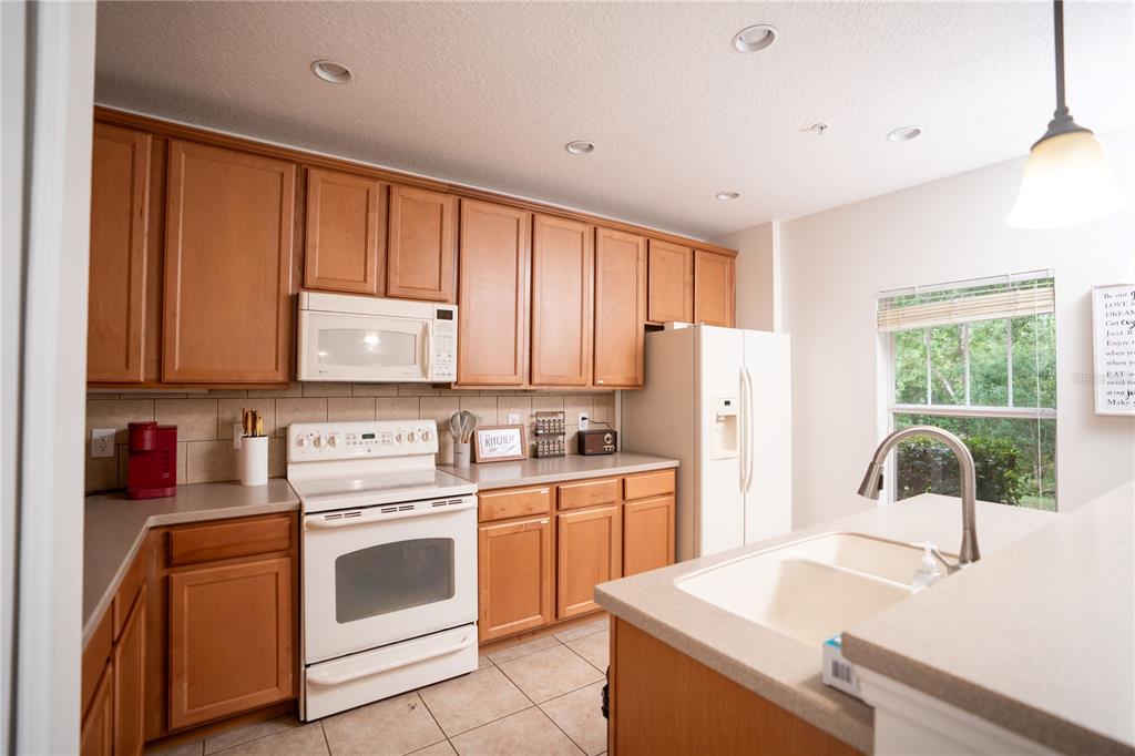 A bathroom features a ruffled gray shower curtain, a wood vanity, and a wall mirror — 9734 TIRAMASU TRAIL, ORLANDO, FL